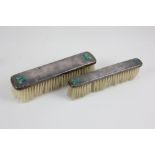 Archibald Knox, two Liberty & Co silver clothes brushes, inlaid in enamel with Celtic knots,