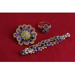 An amethyst bracelet in 9ct gold; a gold and amethyst twelve stone brooch; an amethyst and diamond