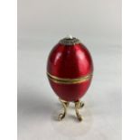 A silver gilt and crimson enamel musical egg by Robert Glover, London 1987 numbered 5/200