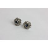 A pair of white and blue stone ear studs in silver