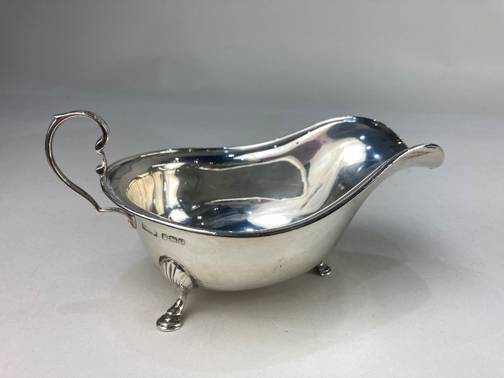 A George V silver sauce boat, maker possibly Hamilton Laidlaw & Co, Sheffield 1933, with scroll