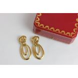 Cartier. A pair of large 18ct gold ear clips of double loop design signed and numbered 28185, in