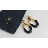 Van Cleef and Arpels; a pair of 18ct gold and black onyx drop earrings hung with a large oval loop