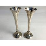 A pair of Edward VII silver posy vases on tapered knopped stems and loaded circular bases,