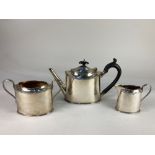 A George V silver three piece tea set, maker Barker Brothers, Chester 1922, of plain oval form