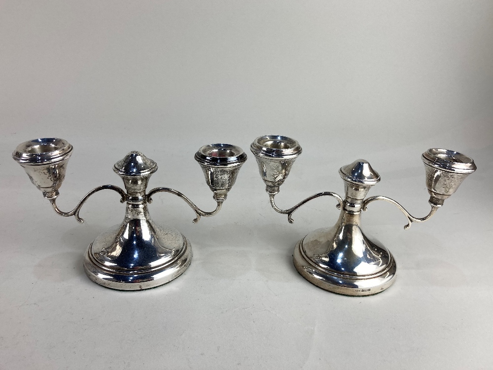 A pair of Elizabeth II silver dwarf two branch candlesticks, makers Sanders & Mackenzie,