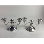 A pair of Elizabeth II silver dwarf two branch candlesticks, makers Sanders & Mackenzie,