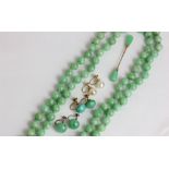 A jade bead necklace; a pair of jade drop earrings; a pair of pearl earrings
