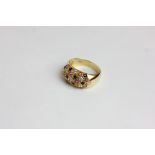 A diamond, ruby and sapphire bombe dress ring in 18ct yellow gold