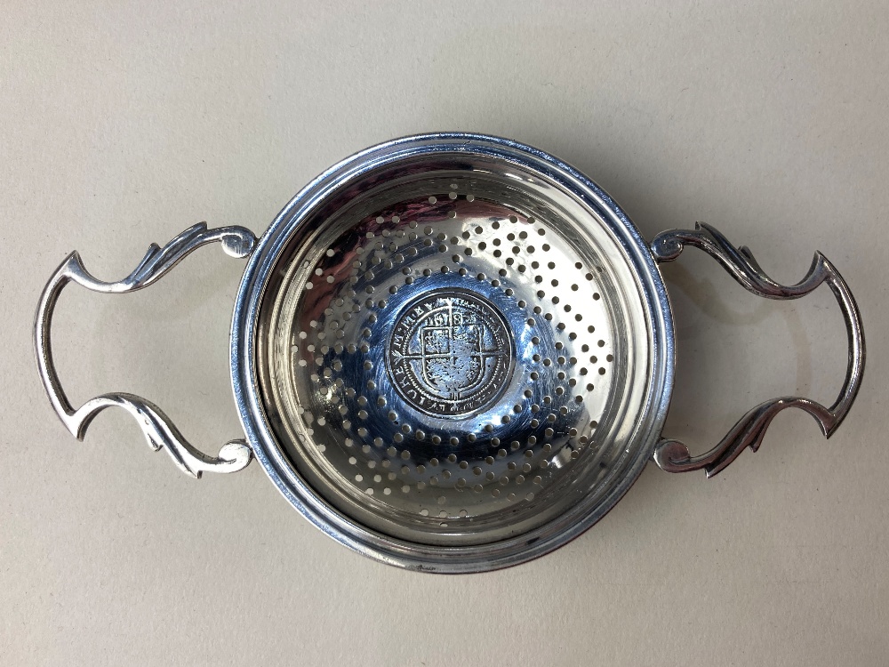 An Edward VIII silver tea strainer, coin inset Elizabeth I sixpence 1582, maker Walker & Hall,