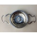 An Edward VIII silver tea strainer, coin inset Elizabeth I sixpence 1582, maker Walker & Hall,