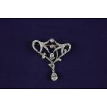 A diamond brooch with pear cut drop