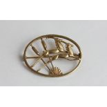 A 9ct gold brooch, by Ivan Tarratt, in the style of Georg Jensen, with two running antelope within