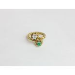 An emerald and diamond ring claw set with a square cut emerald and diamond