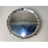 A George V silver circular salver, maker Asprey & Co Ltd, Sheffield 1910, with scalloped border on