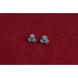 A pair of diamond three stone ear studs the uniform brilliant cuts claw set on post and butterfly
