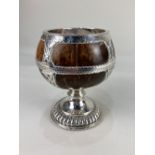 A white metal mounted coconut chalice or pedestal bowl, with engraved and pierced floral design 15cm