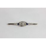 A sapphire and diamond bar brooch millegrain set with graduated old and rose cut diamonds