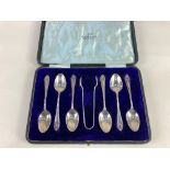 A cased set of six George V silver teaspoons and sugar tongs, maker Walker & Hall, Sheffield 1915,