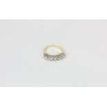 A diamond seven stone half hoop eternity ring in 9ct gold