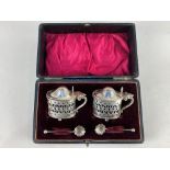 A cased set of two Edward VII silver mustards, maker Marks & Cohen, Birmingham 1902, with unmarked