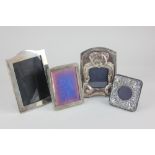 Four silver photograph frames, a small embossed frame with circular aperture, maker DR&S, Birmingham