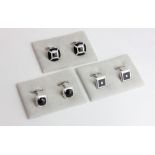 A pair of faceted black onyx and diamond cufflinks in micro set diamond borders, another pair with a