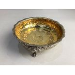 A Victorian silver circular bowl embossed with scrolling foliage and scalloped border, gilt interior