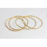 A set of four gold bangles stamped 21ct 34.3g