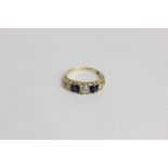 A sapphire and diamond ring claw set with three graduated old cut diamonds and two round sapphires
