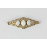 An opal brooch claw set with three graduated oval cuts