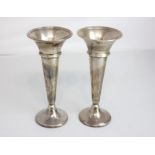 A pair of George V silver vases tapered form on loaded circular bases, London 1919, 18cm high