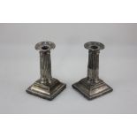 A pair of Victorian silver dwarf column candlesticks, makers mark worn, London 1899, (a/f) 13cm