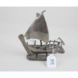 An Arabic white metal model of a dhow sailing ship, stamped Cheeky Jewellers, Sharjah, (Dubai)
