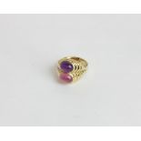A cabochon amethyst and pink tourmaline two stone ring in 18ct yellow gold 9.9g gross