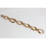 An 18ct rose gold oval link bracelet with smaller pavé set diamond links between 63.3g gross