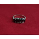 A garnet five stone ring in 9ct gold