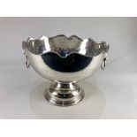 A silver plated punch bowl, with scalloped gadroon rim, lion mask ring handles and pedestal base,