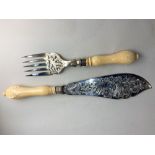 A pair of Victorian silver fish servers fork and knife with pierced blade of birds amongst flowers