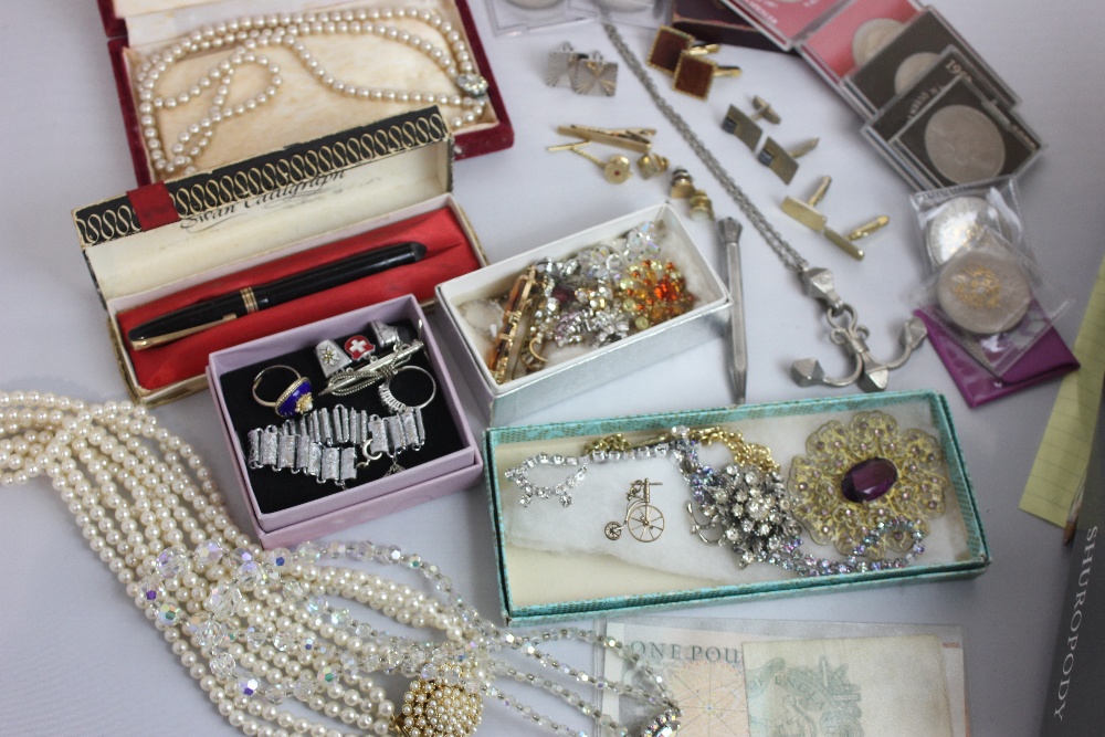 A collection of costume jewellery and commemorative coins and bank notes