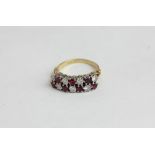 A ruby and diamond two row half hoop ring in 18ct gold