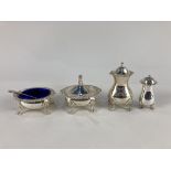 An Elizabeth II silver three piece cruet set, maker E J Houlston, Birmingham 1965, with blue glass