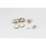 An amethyst ring in 9ct gold, six various full and half hoop eternity rings variously gem set (