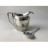 A Victorian silver cream jug, maker Florence Warden, Chester 1895, monogrammed, together with a