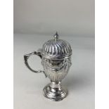 A Victorian silver mustard, maker Walker & Hall, Sheffield 1895, of embossed pedestal form, with
