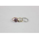 A platinum wedding ring 5.6g; a diamond single stone ring in 9ct gold; a cabochon star corundum