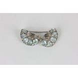 An aquamarine and rose cut diamond double clip brooch set with round and trapezoid cut aquamarines