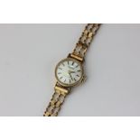 A lady's 9ct gold Tissot watch on a associated bracelet