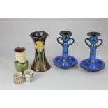 A pair of Torquay Art Pottery blue glazed candlesticks, decorated with birds and trees, 21cm high, a