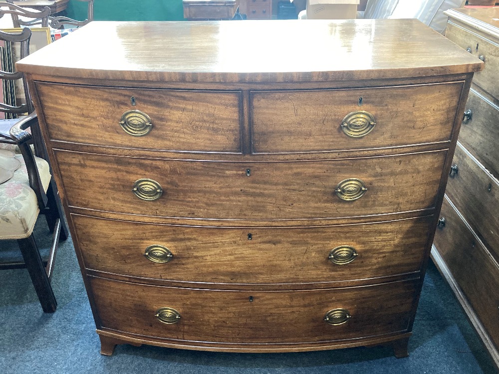 A 19th century mahogany bow front chest of two short over three long graduated drawers, with oval